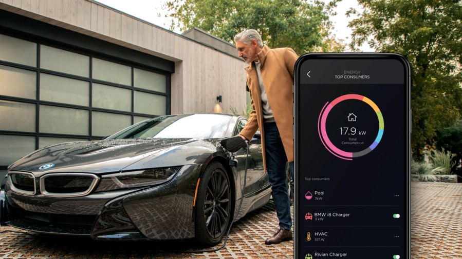 Savant Power smartphone interface inset in front of a man looking at an electric vehicle.