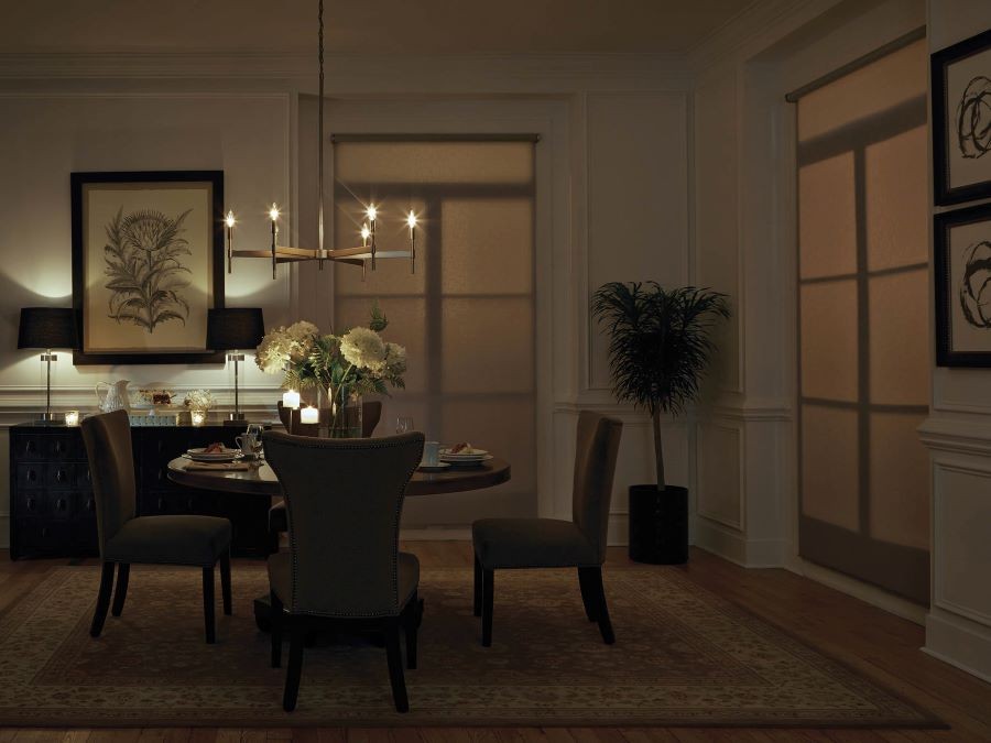 A soft-lit dining area with Lutron shades lowered.