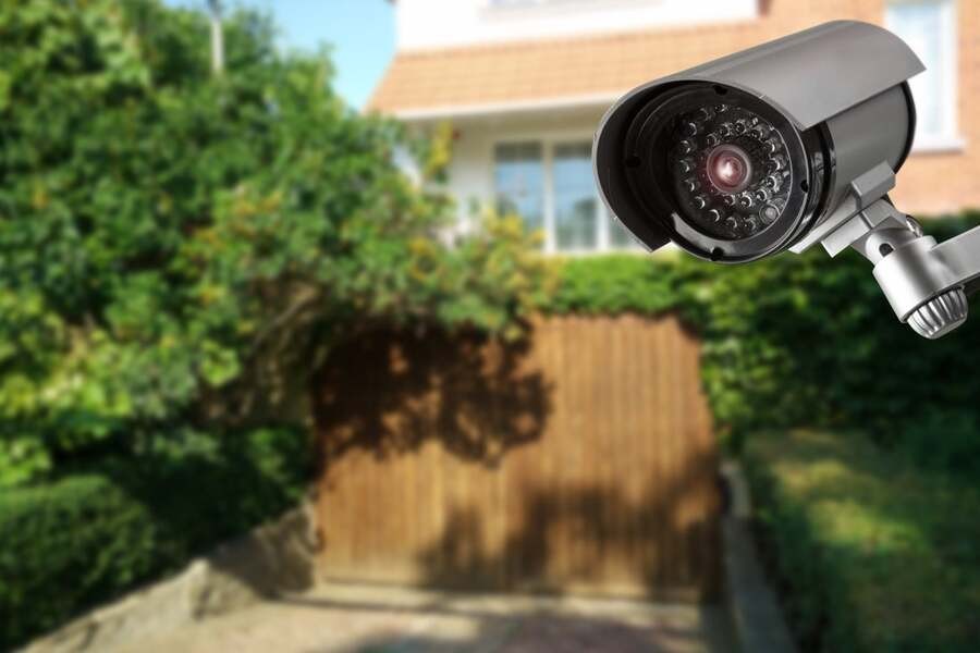 A security camera overlooks a home’s backyard.