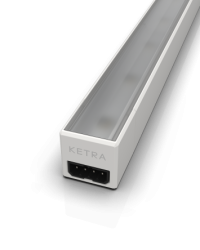 Close-up of a slim rectangular Ketra linear light fixture, showing the frosted lens on top and a black power connector port on the white end cap.